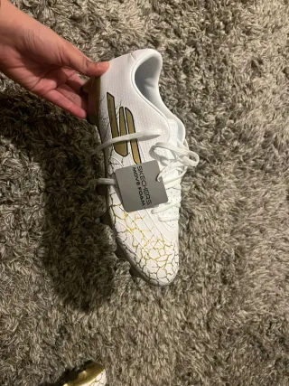Botas de fútbol Skechers Blancas y Doradas