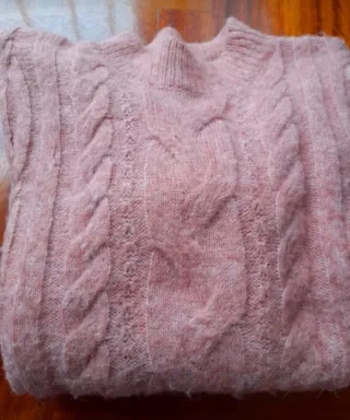 Maglione rosa lavorato a trecce
