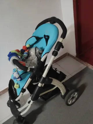 Carrito de bebé azul con saco y plástico