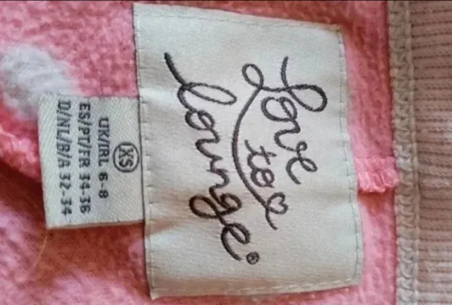 Pijama entero rosa lunares blancos