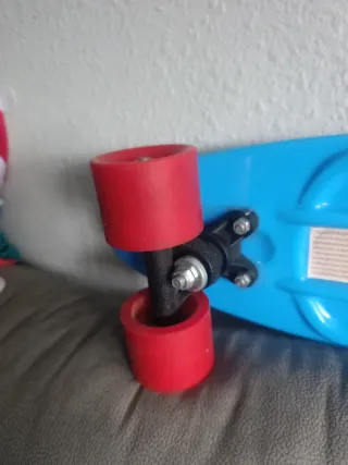 Patinete monopatín azul con ruedas rojas