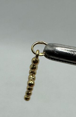 Colgante Cruz Bolas de oro de 18k, 0.56 g.