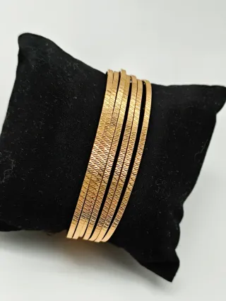 7 Pulseras Semanario con tallas oro 18kt