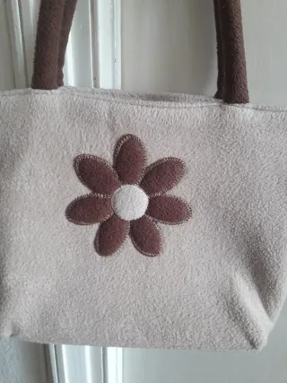 Bolso de tela beige con flor marrón