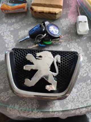 Insignia Peugeot León Cromada