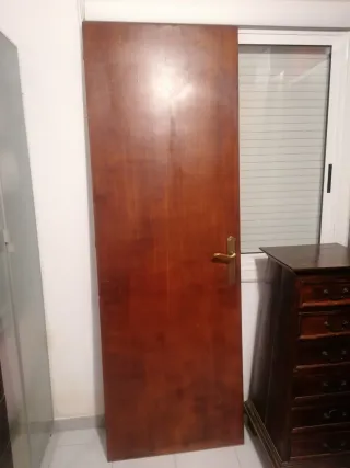 Puerta de madera marrón y manetas