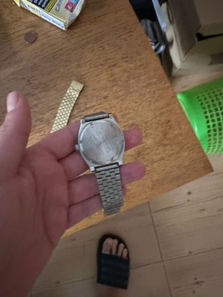 Reloj Nixon Negro y Plateado y blanco y dorado