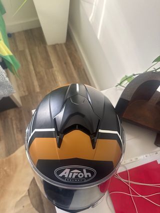 Casco de moto Airoh negro y dorado