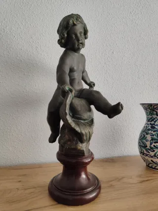 Figura niño en concha de bronce