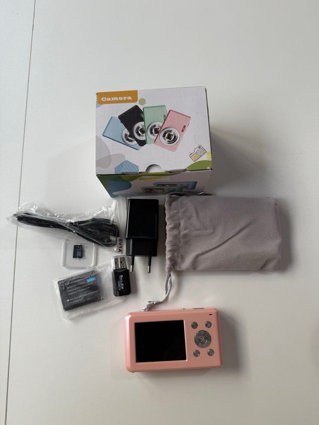 Cámara digital rosa con accesorios