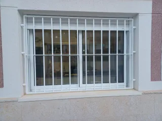 Ventana aluminio blanca con rejas