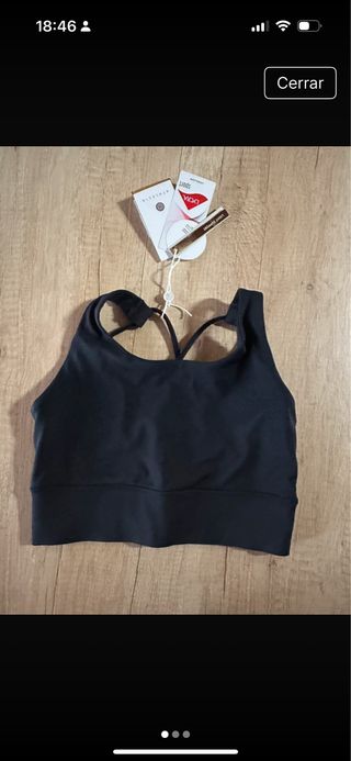 Top deportivo Athlecia negro con etiquetas