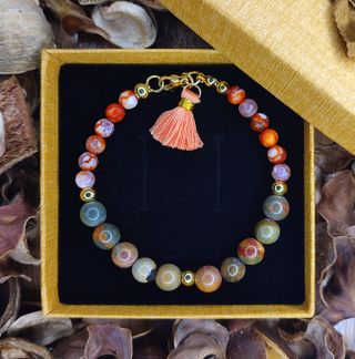 Pulsera ágata tierra con cuentas doradas y borla