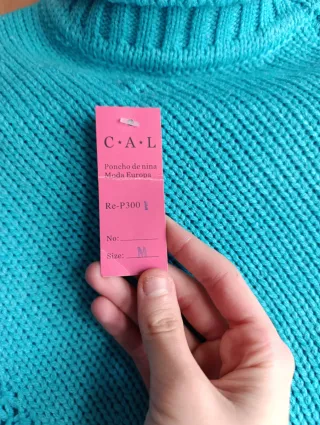 Poncho azul con cuello alto y flecos