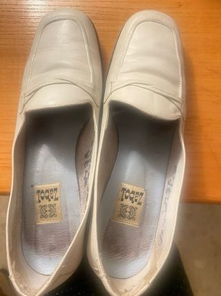 Zapatos blancos grisáceos.