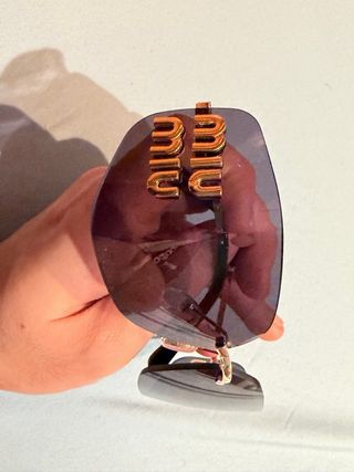 Occhiali da sole Miu Miu neri e dorati