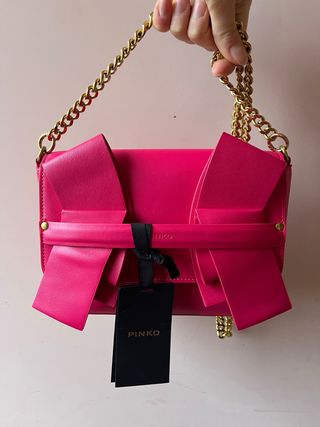 Borsa Pinko fucsia con fiocco e catena oro