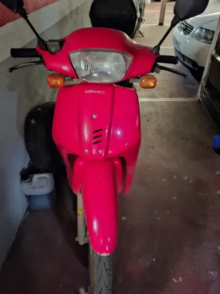 Ciclomotor rosa con baúl