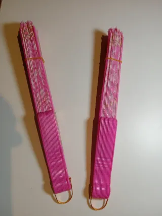 Dos abanicos color rosa con detalles dorados