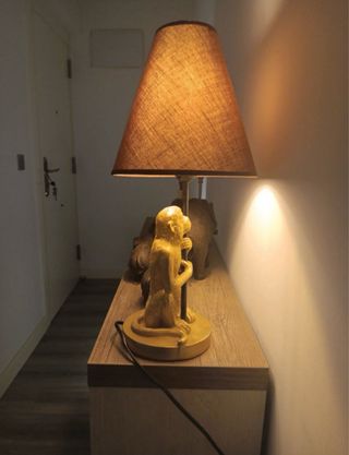 Lámpara mono dorado sentado