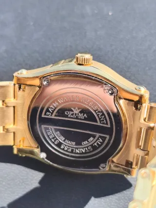 Reloj Optima Negro y Dorado Mujer Negociable