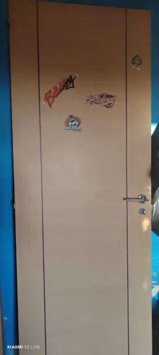 Puerta de madera clara con manilla