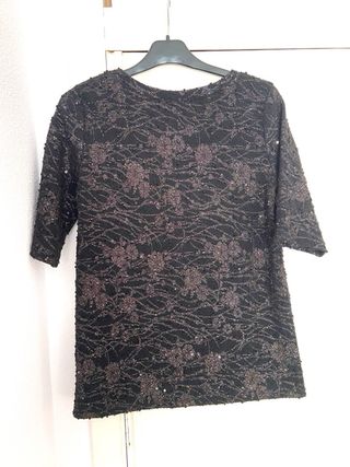Blusa elegante negra con detalles plateados