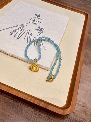 Collar piedras azules y Buda dorado