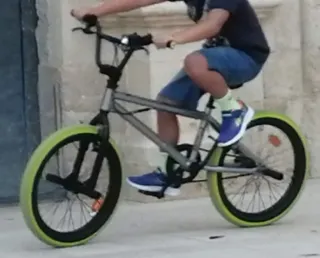 Bicicleta BMX gris con ruedas verdes
