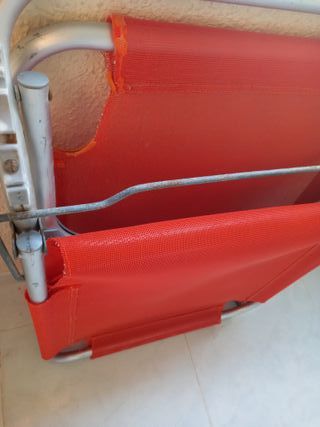 Tumbona plegable roja y plateada