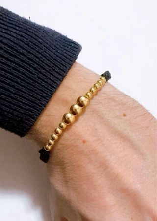 Bracciale in stoffa con sfere lucide oro 18kt