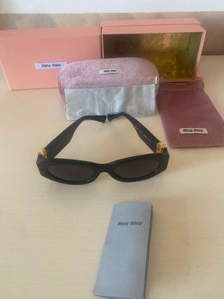 Occhiali da sole Miu Miu neri e oro