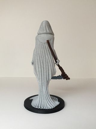 Statua guardiana con falce