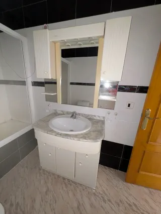 Mueble de baño con lavabo de mármol y espejo