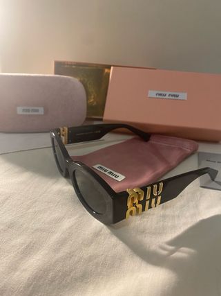 Occhiali da sole Miu Miu neri e oro