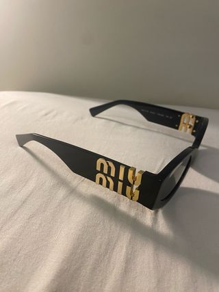 Occhiali da sole Miu Miu neri e oro