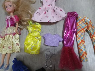Muñeca con vestidos y accesorios