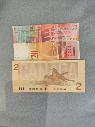 20 francos suizos y 2 dólares canadienses