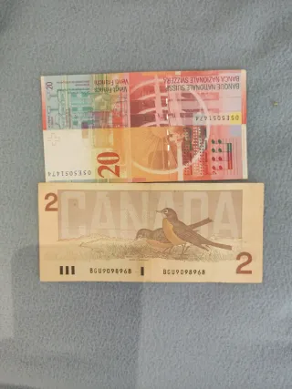 20 francos suizos y 2 dólares canadienses