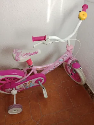 Bicicleta infantil rosa con ruedas de apoyo