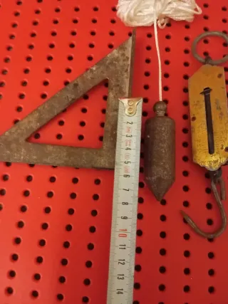 Herramientas antiguas: escuadra, plomada, báscula