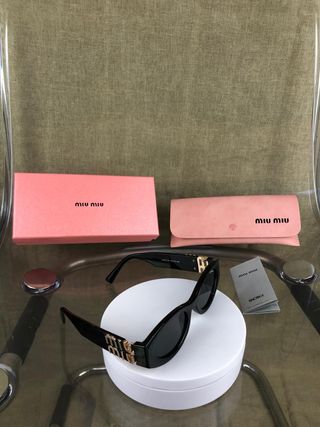 Occhiali da sole Miu Miu neri e dorati