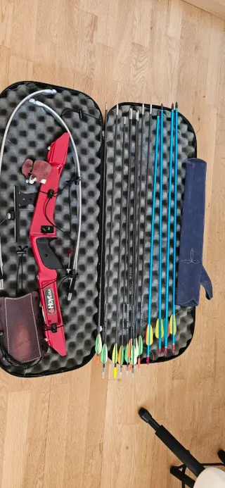 Arco recurvo rojo y flechas, sin cuerda