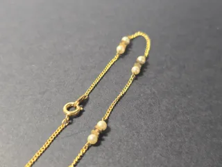 Pulsera dorada con perlas