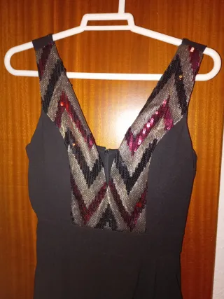 Mono negro con detalles dorados y rojos