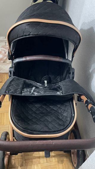 Carrito bebé cuco negro y dorado