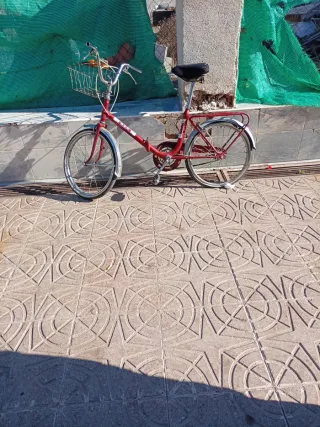 Bicicleta roja plegable con cesta