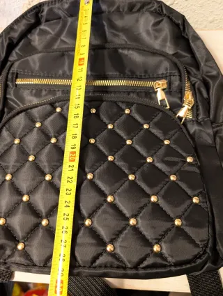 Mochila negra con tachuelas doradas