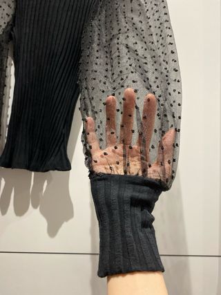 Blusa negra con mangas de tul.