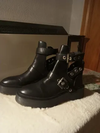 Botas negras con hebillas y cortes